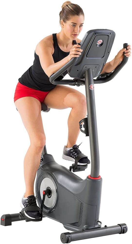 A lady is riding the Schwinn 170 Upright Bike
