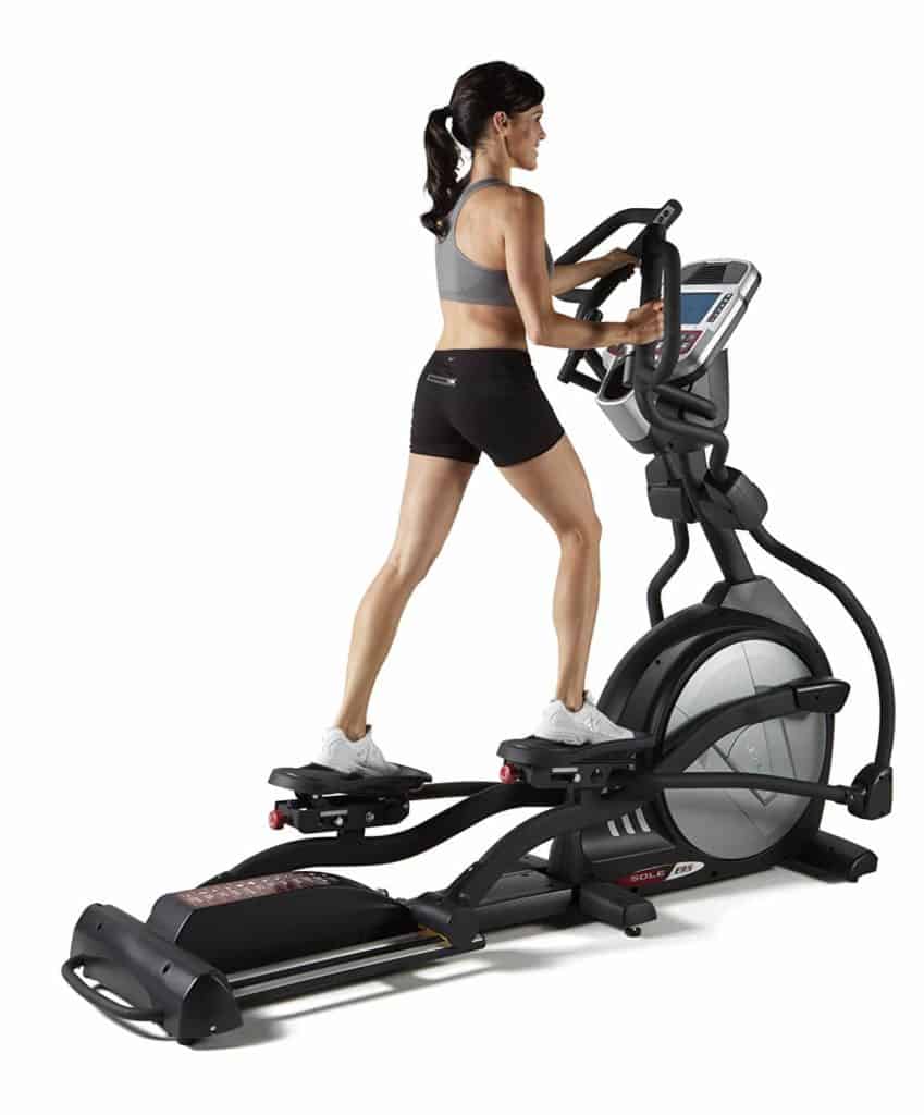 A lady is working out on the Sole E95 Elliptical
