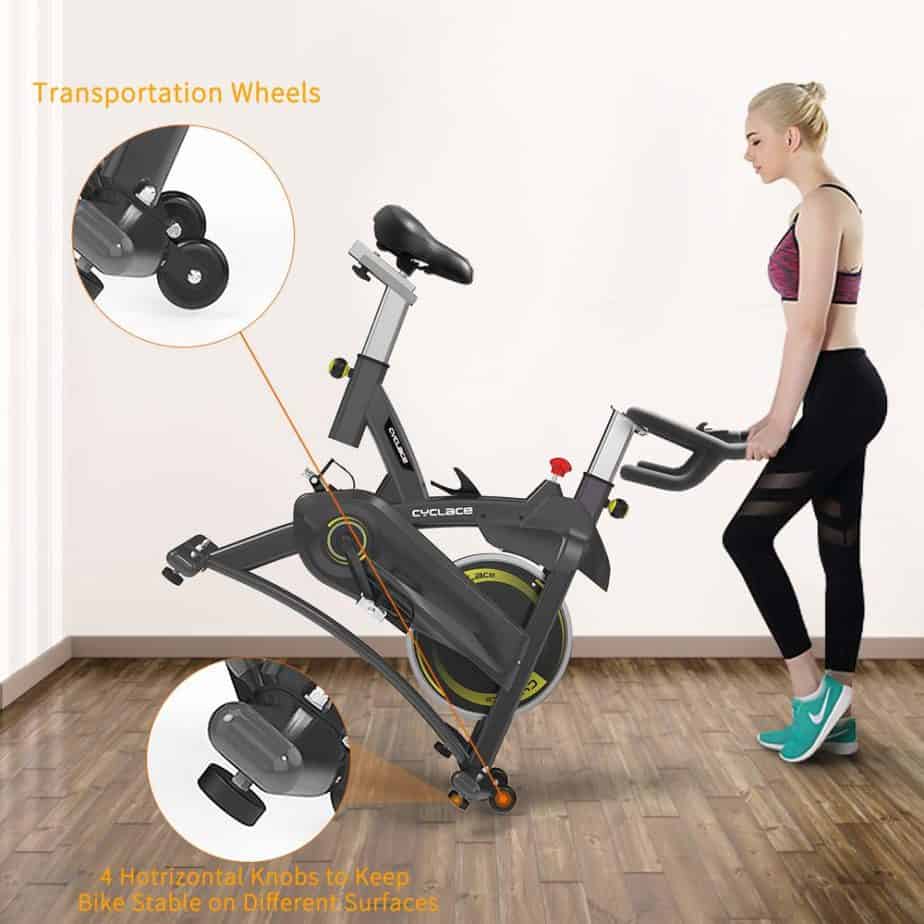 The Cyclace Indoor Exercise Bike is being moved to storage by a lady