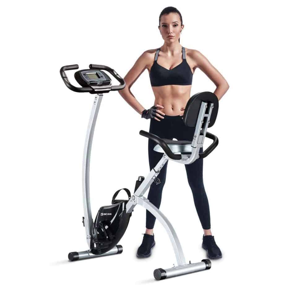 An athlete standing beside the BCAN Folding Exercise Bike
