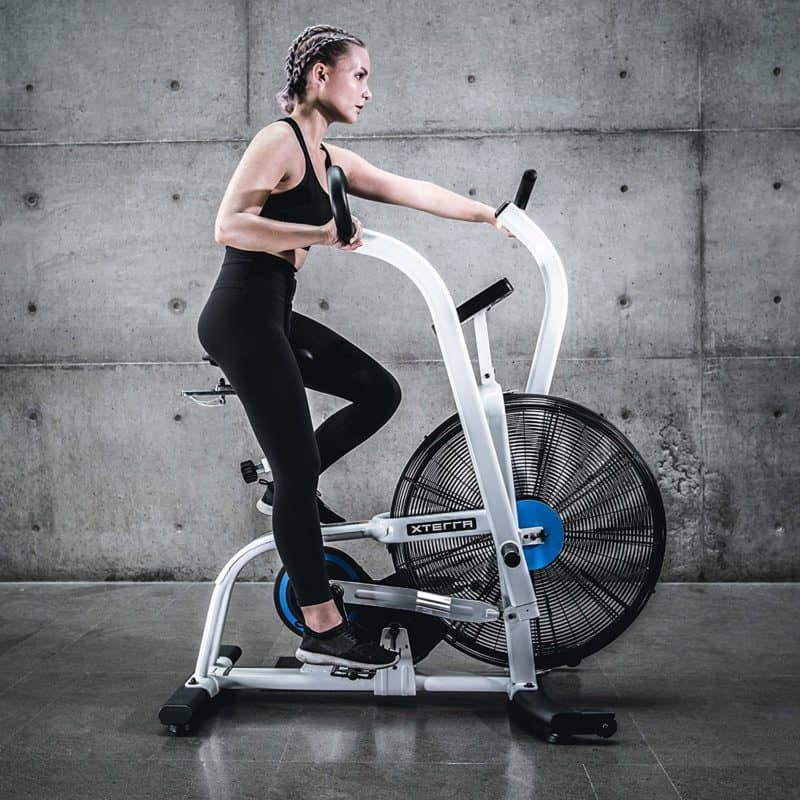 A lady riding the XTERRA Fitness AIR650 Airbike Pro