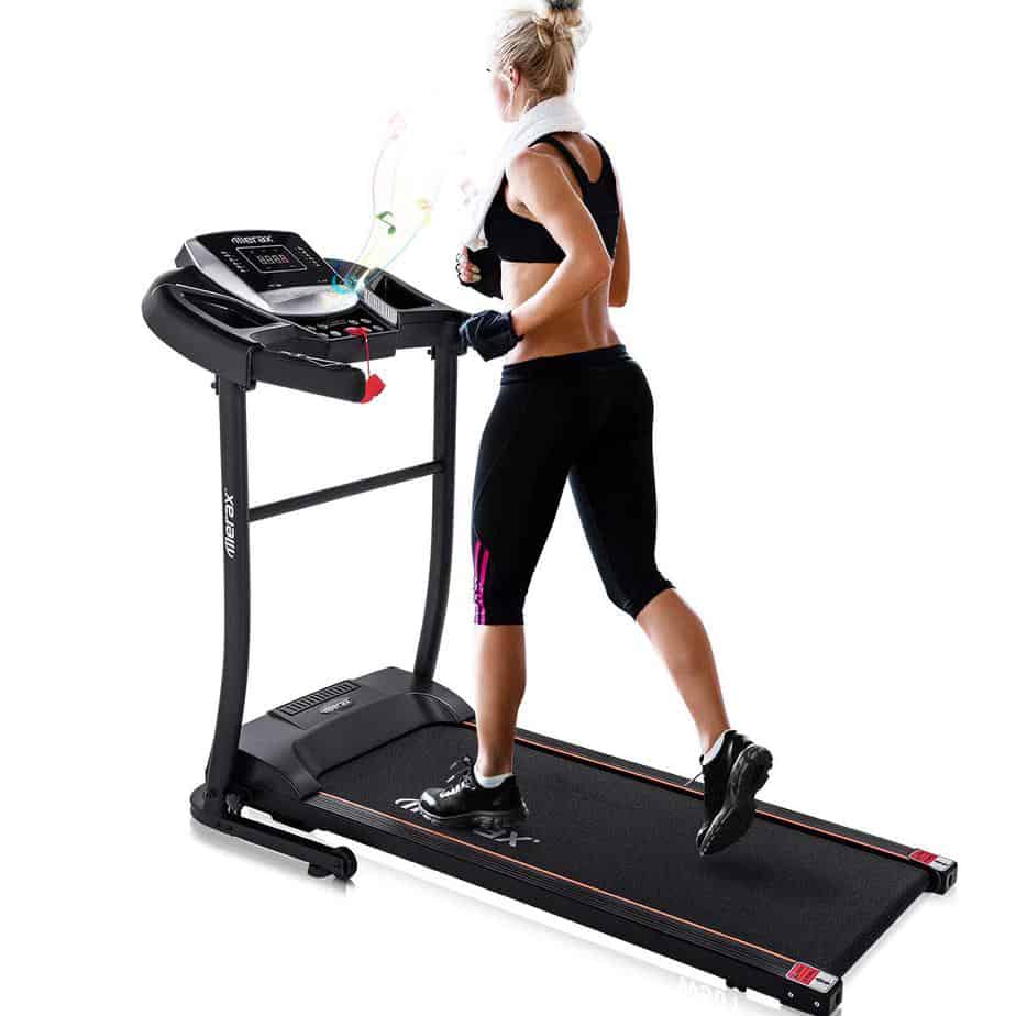 A lady is running on the Merax Folding Treadmill