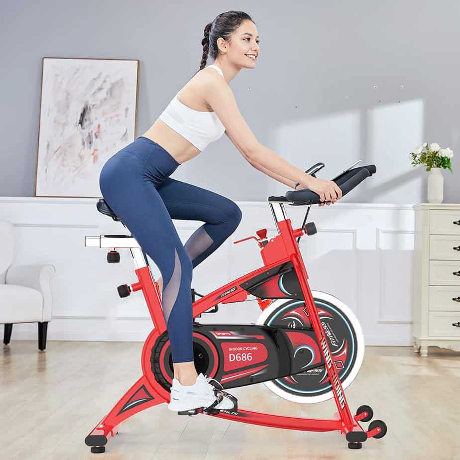 A lady rides the Pooboo D686 Indoor Cycling Bike
