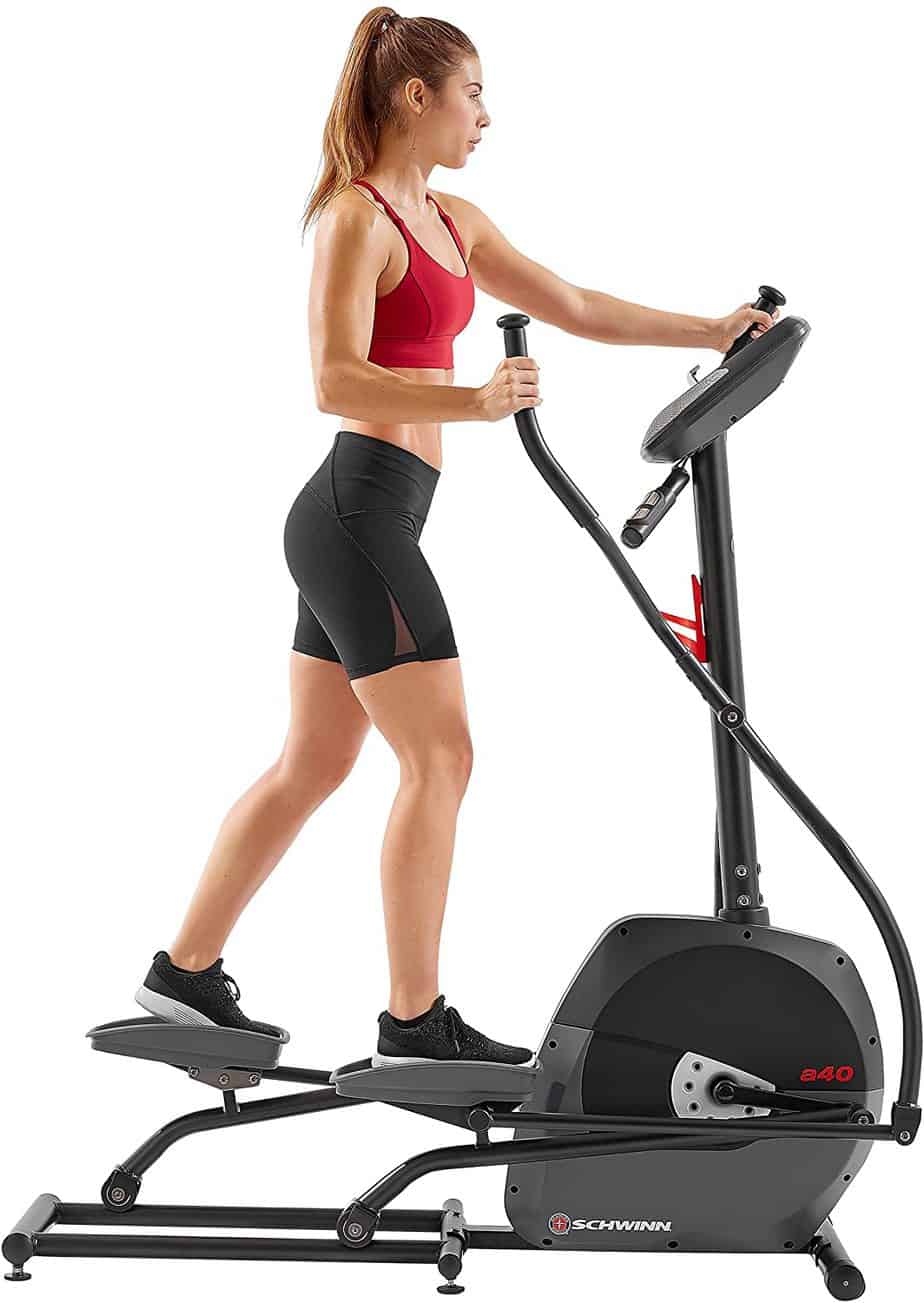 A lady is working out with the Schwinn A40 Compact Elliptical 100330