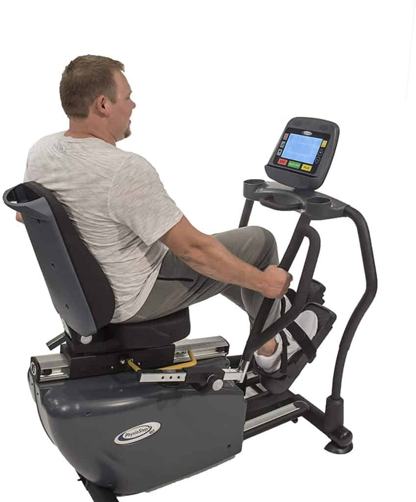 A man works out on the HCI Fitness PhysioStep RXT-1000 Recumbent Elliptical Trainer