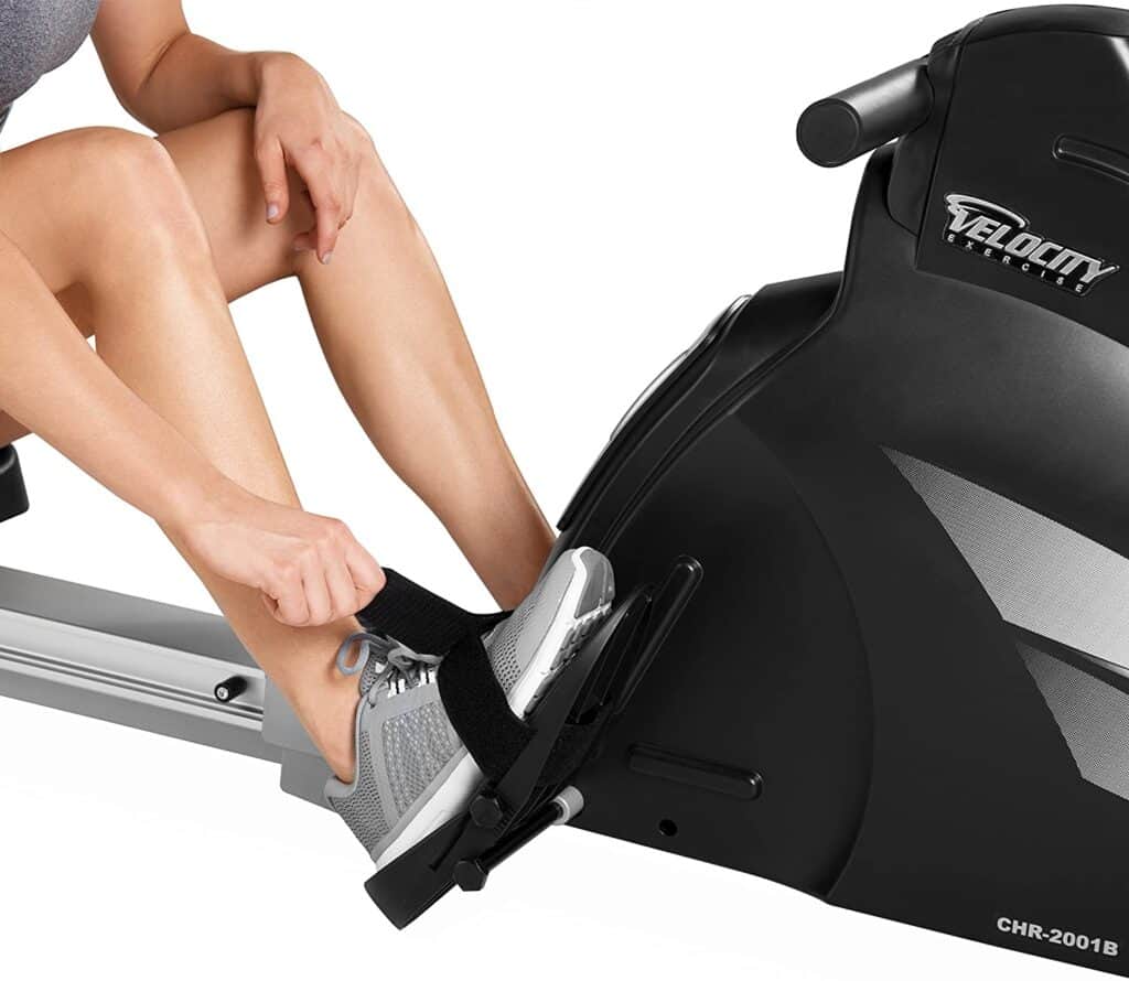 A lady is strapping up the pedal for a workout