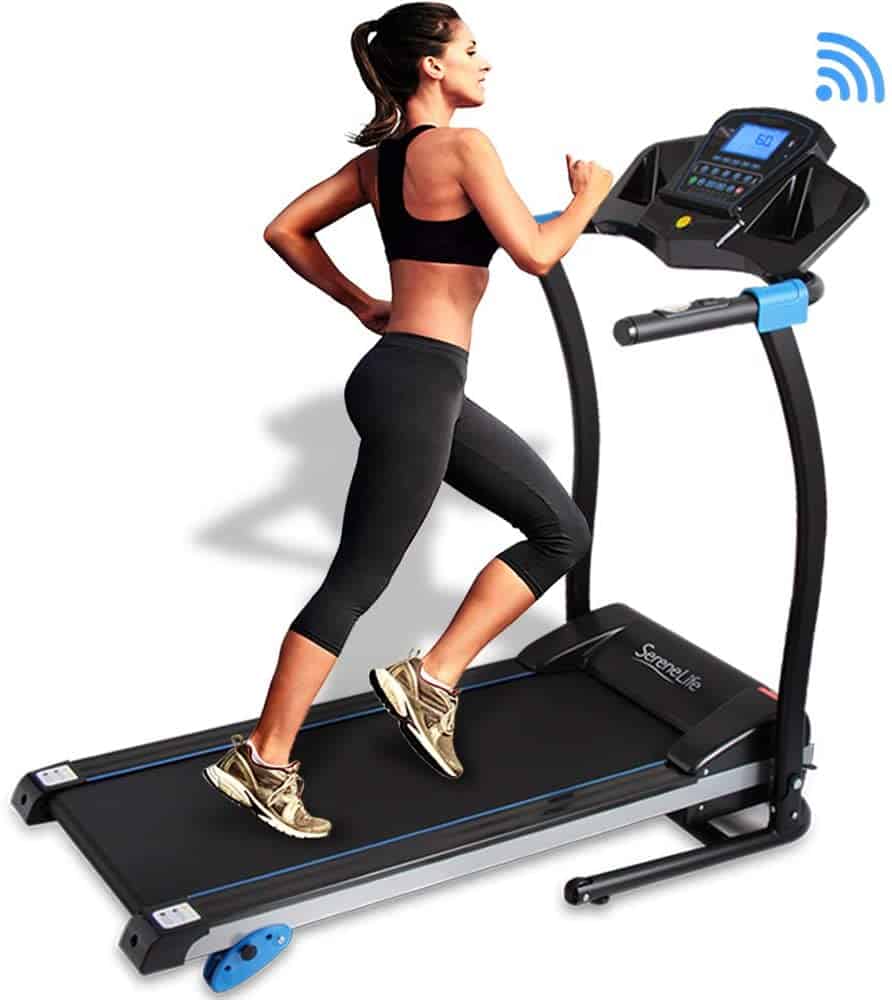 A lady runs on the SereneLife SLFTRD25 Smart Folding Treadmill