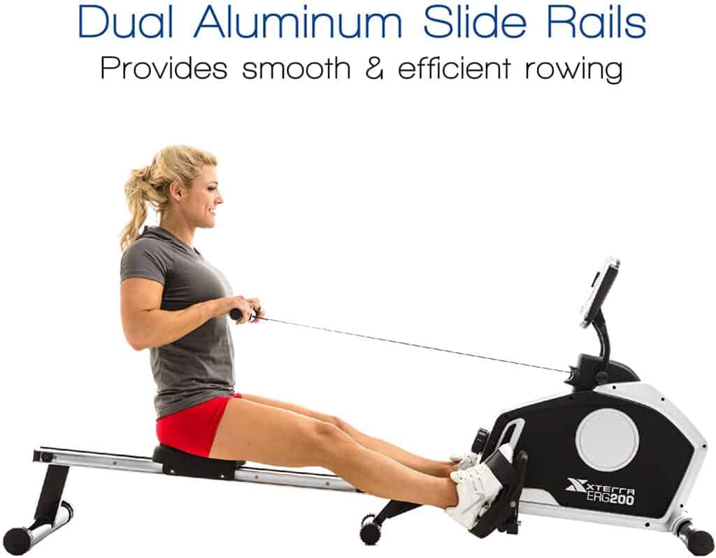 A lady exercises with the XTERRA Fitness ERG200 Magnetic Rowing Machine