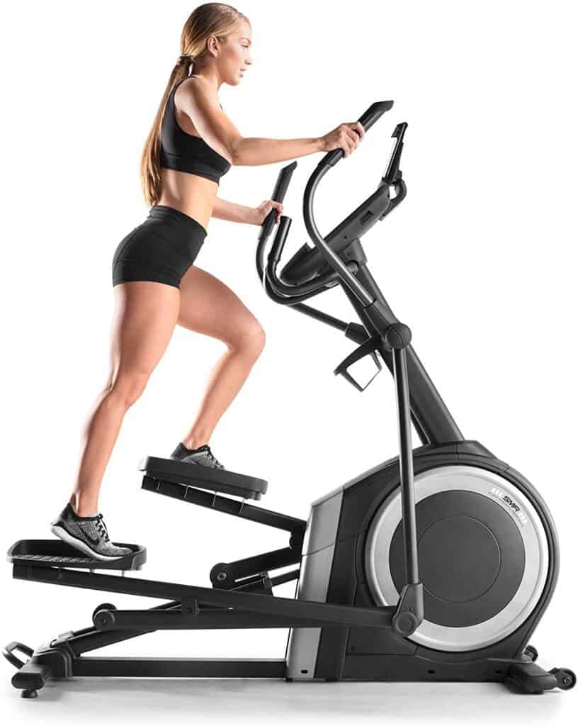 A lady exercises with the NordicTrack NTEL71218 C 12.9 Elliptical Trainer