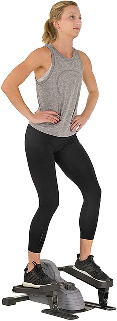 A lady exercise on the Sunny Health & Fitness SF-E3908 Under-Desk/Standing Portable Elliptical Machine while standing