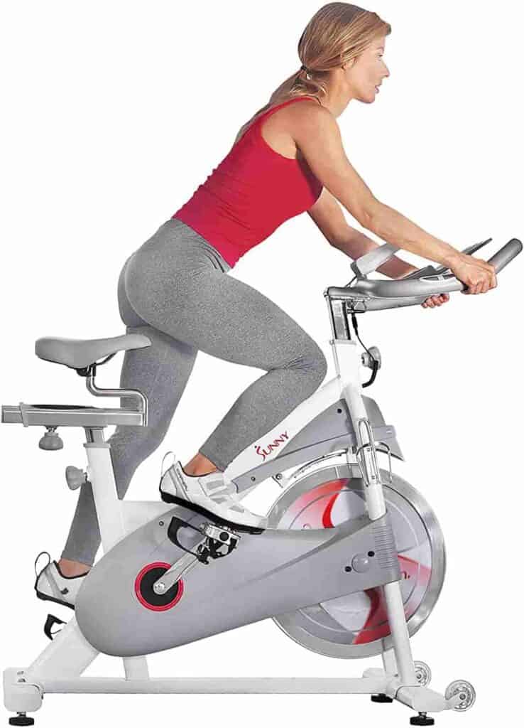 A lady rides the Sunny Health & Fitness SF-B1876 Magnetic Resistance Cycling Bike