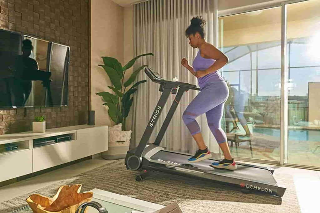 A lady runs on the Echelon Stride Treadmill 