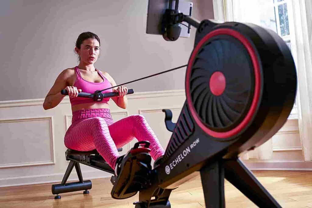 A woman exercises on the Echelon Smart Rowing Machine