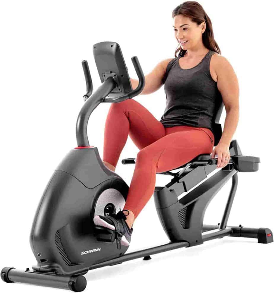 A lady exercises with the Schwinn 230 (MY20) Recumbent Bike