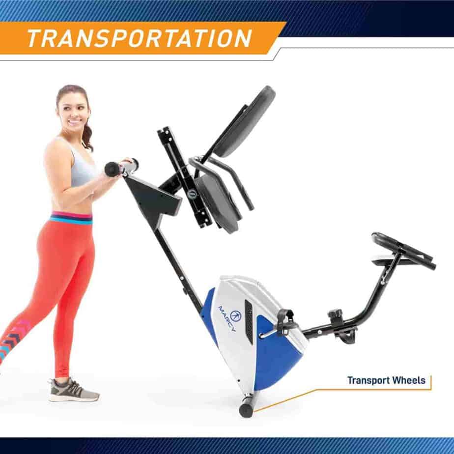 The lady rolls the Marcy Recumbent Bike ME-1019R   away for storage