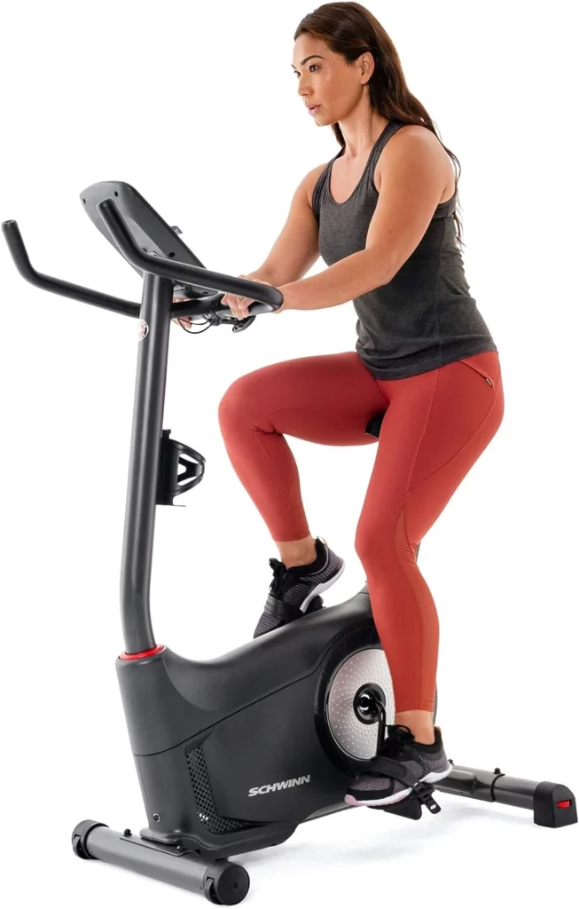A lady rides the Schwinn 130 (MY20) Upright Bike
