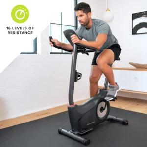A man exercises with the Schwinn 130 (MY20) Upright Bike 