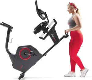 A lady moves the Sunny Health & Fitness SF-4850SMART Recumbent Bike to a storage area
